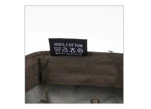 Macro view of 100% cotton wash label and internal stitching on dark brown cadet cap