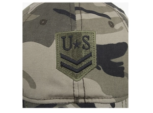 Macro detail of the high-density US shield embroidery on camouflage canvas baseball cap