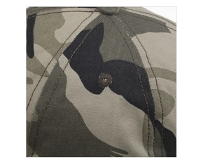 Macro shot of camouflage baseball cap crown featuring metallic eyelets and neat stitching