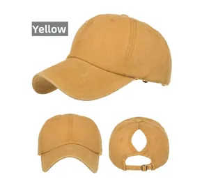 Detail view of mustard yellow ponytail baseball cap with vintage washed cotton fabric and metal buckle
