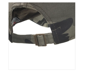 Detail of camouflage baseball cap with adjustable bronze buckle and woven fabric texture