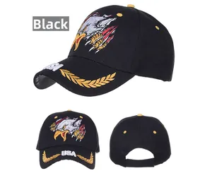 Detail of embroidered eagle and USA logo on a black cotton baseball cap with golden wheat