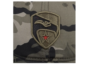 Close-up of the star and eagle shield embroidery on the camouflage canvas baseball cap