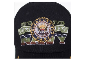 Detailed close-up of United States Navy eagle embroidery on black cotton baseball cap