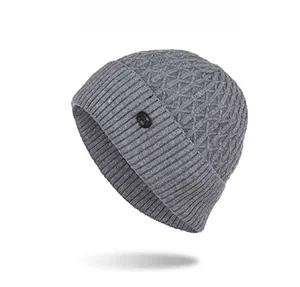 Gray knitted beanie with diamond texture and ribbed cuff showing the leather patch detail