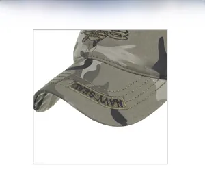 Detailed close-up of navy seal embroidery and camo texture on a cotton baseball cap