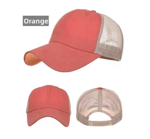 Detail view of washed cotton orange yellow trucker hat with breathable mesh and adjustable strap