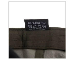 Detail shot of the 100% cotton material label and care instructions for the camo baseball cap