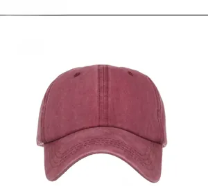 Front view detail of a burgundy washed cotton ponytail baseball cap with distressed finish