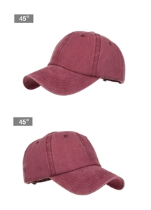 Detail view of burgundy washed cotton baseball cap with ponytail hole and vintage texture