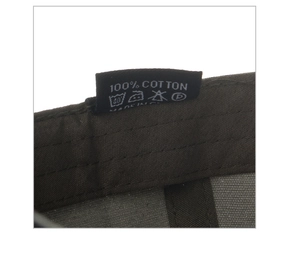 Detailed macro view showing the 100% cotton material tag and quality stitching on the cap