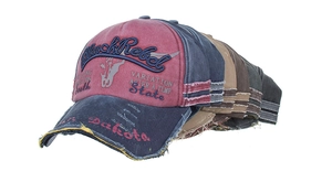 Detail of distressed washed cotton baseball caps with BlackRebel embroidery and worn edges