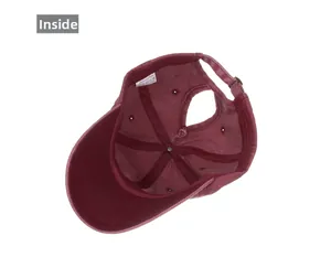 Detail of burgundy washed cotton baseball cap showing internal ponytail hole structure