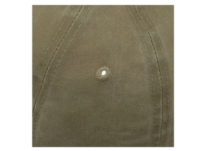 Macro detail of military green washed cotton baseball cap with ventilation eyelet