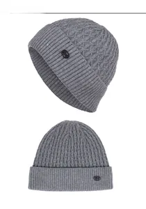 Detailed close-up showing gray branch-textured knit beanie with FASHION leather label
