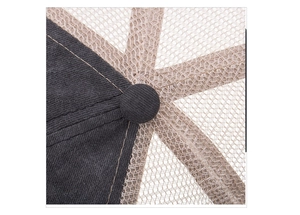 Detail of a trucker hat top featuring black twill fabric and khaki honeycomb mesh texture
