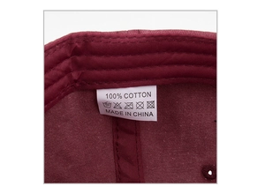 Macro view of 100% cotton washed baseball cap inner stitching and care labels