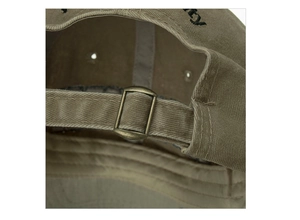 Detail of adjustable bronze metal buckle and washed cotton texture on khaki baseball cap