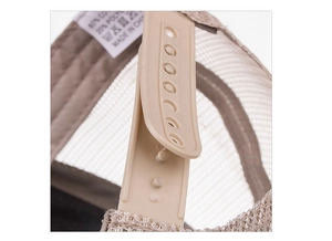 Macro view of adjustable snapback strap and breathable mesh on cotton trucker hat