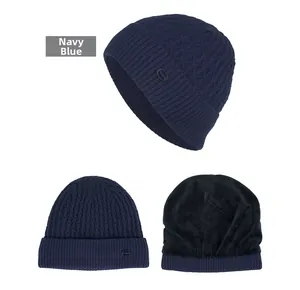 Navy blue knit beanie featuring thick black fleece lining and textured diamond pattern