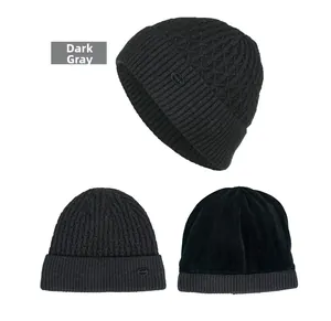 Detail of dark grey knit beanie with plush lining and decorative Fashion logo plate