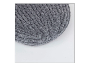 Close-up of dark grey thick rib-knit texture and stitching detail on the winter scarf