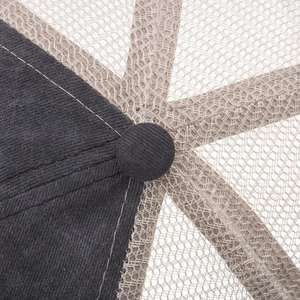 Close-up of washed cotton baseball cap top button with dark grey corduroy and beige mesh