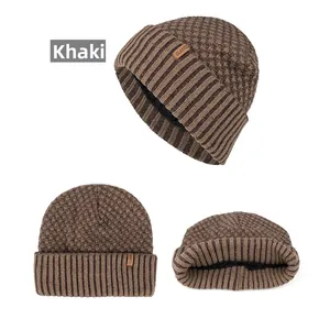 Detail of khaki knit beanie with classic label and warm black fleece lining