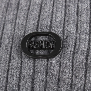 Winter ribbed grey knit beanie with a thick texture and black Fashion rubber badge