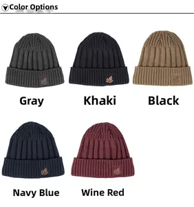 Detailed close-up of ribbed knit beanies featuring decorative brown maple leaf patches