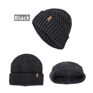 Close-up of black marled knit beanie showing classic leather patch and ribbed texture