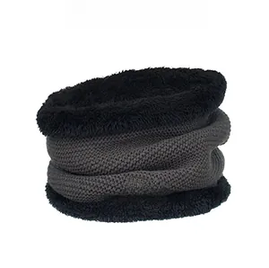 Detail of dark grey knitted neck gaiter with thick black fleece lining and leather logo