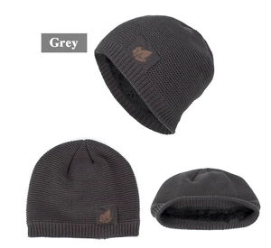 Detailed view of dark grey winter beanie featuring thermal fleece lining and leaf patch