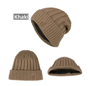 Detail of khaki ribbed knit beanie showing thick black fleece lining and leaf embroidery