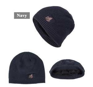 Detailed view of navy knit beanie featuring warm fleece lining and maple leaf leather patch
