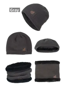 Close-up of grey knit hat and scarf set with leaf leather patch and warm fleece lining