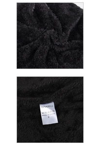Detail of soft black 100% acrylic fleece texture and white laundry care label on the beanie