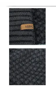 Macro detail of dark grey ribbed knit beanie with brown faux leather Classic label