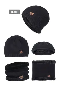 Detail showing plush faux fur lining and maple leaf patch on black knit winter set