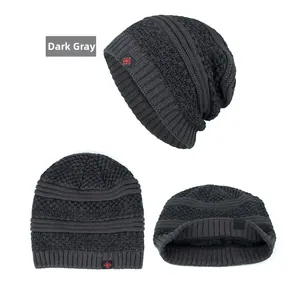 Detail of dark grey knit beanie with textured weave and red snowflake fabric label