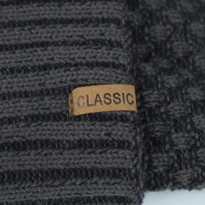 Deep grey chunky knit beanie with a brown classic leather label for winter warmth