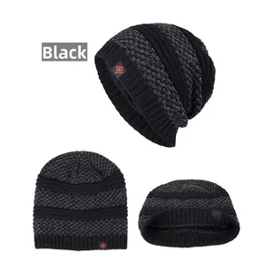Detailed view of black striped knitted beanie with red snowflake patch and ribbed edge