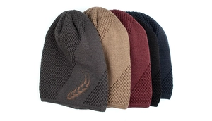 Detail of five colored beanies showing wheat ear embroidery and knit texture