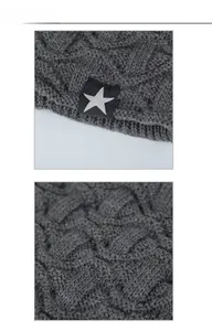 Vue détaillée du tricot torsadé gris foncé avec logo étoile blanche sur l'étiquette en tissu