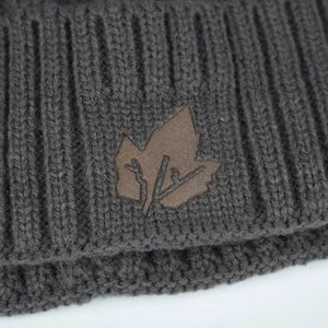 Dark grey ribbed knit beanie for winter with an embossed leaf-shaped leather patch