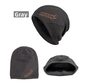 Detail view of dark grey knit beanie with warm fleece lining and wheat embroidery decoration