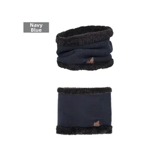 Detail of navy blue knitted neck warmer with maple leaf leather patch and plush fleece lining
