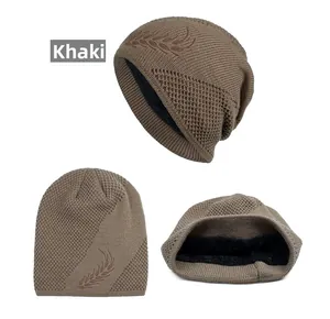 Detail view of khaki knit beanie featuring leaf embroidery and warm black fleece lining