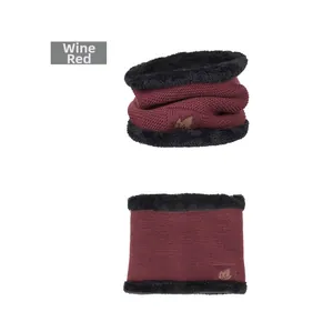 Detail of burgundy knitted neck gaiter with leaf logo and warm black fleece lining