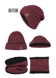 Detail of burgundy knit hat and neck warmer with thick black fleece lining and leaf patch